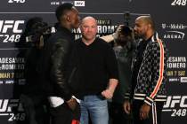 UFC middleweight champion Israel Adesanya left, faces off with his opponent, Yoel Romero, right ...