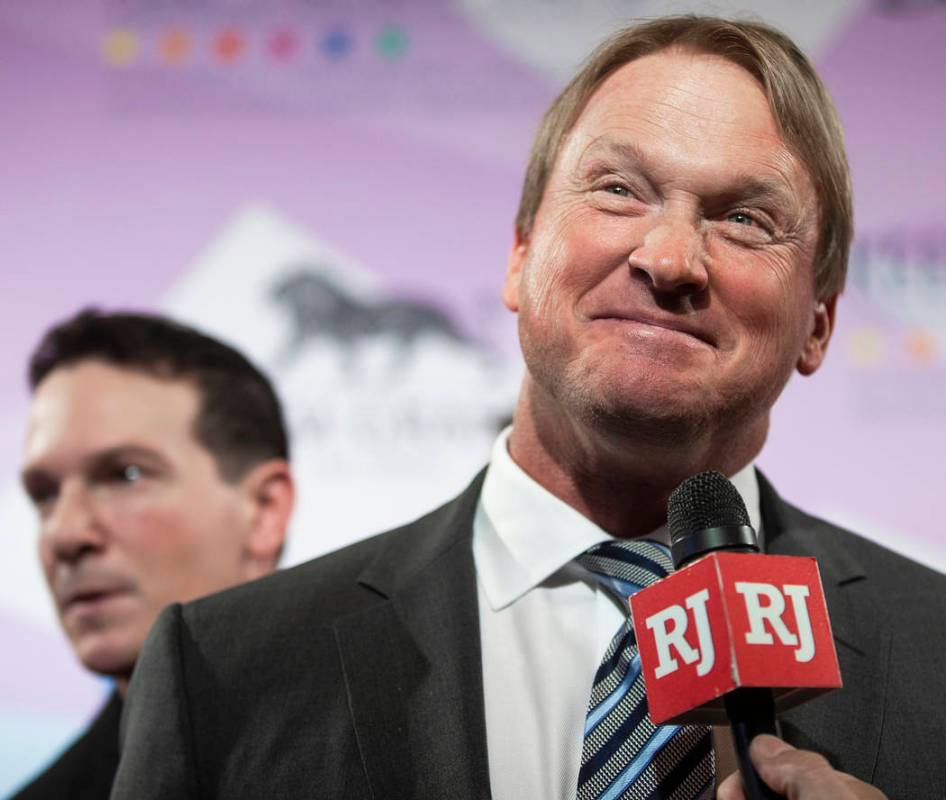 Raiders head coach John Gruden, right, talks with the media on the red carpet during the 24th A ...