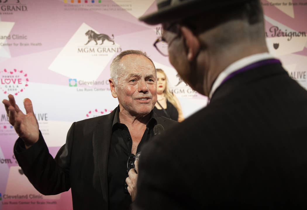 Wolfgang Puck talks with the media on the red carpet during the 24th Annual Power of Love Gala ...