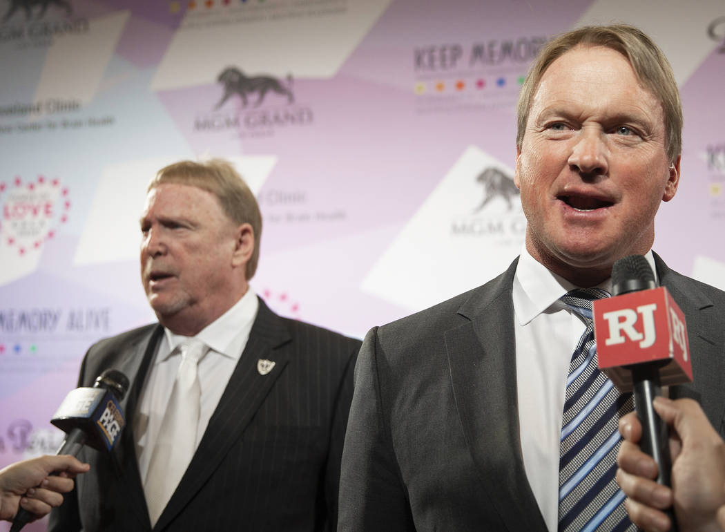 Raiders head coach John Gruden, right, and Raiders owner Mark Davis talk with the media on the ...