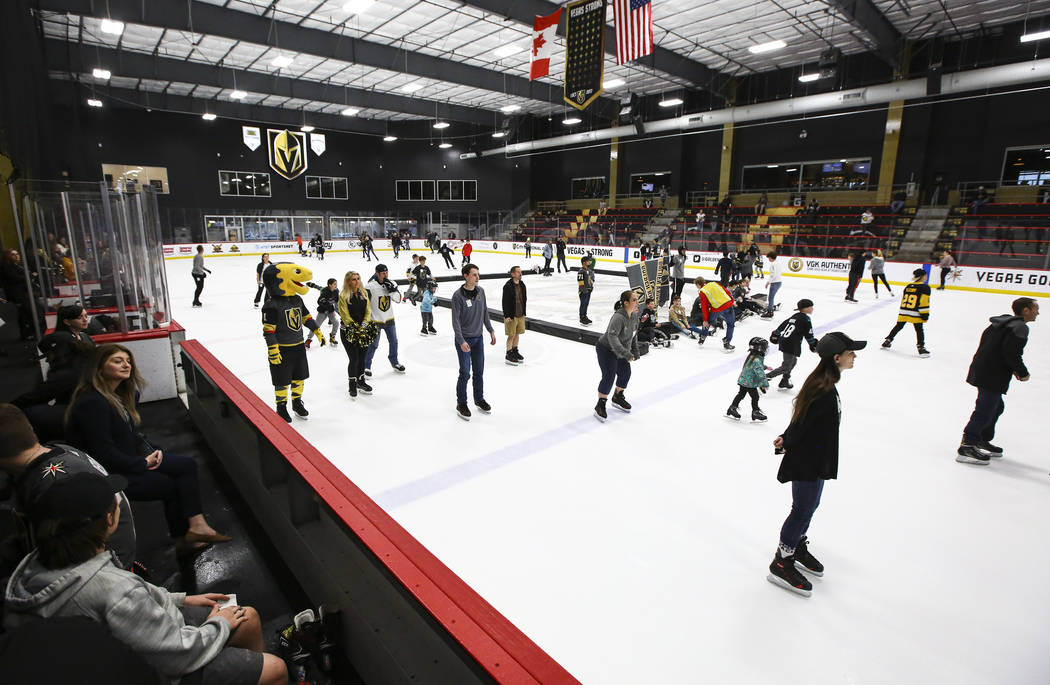 Golden Knights fans skate on the ice at City National Arena during a watch party for an away ga ...