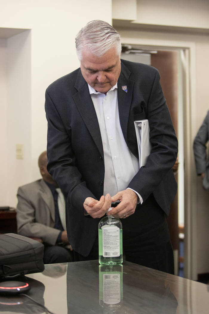 Governor Steve Sisolak uses hand sanitizer before providing a press briefing on the new coronav ...