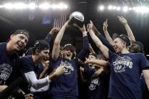 Utah State's Sam Merrill hoists the trophy for MVP after defeating San Diego State in an NCAA c ...