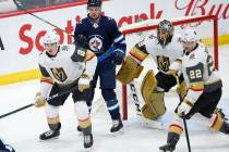 Vegas Golden Knights' Zach Whitecloud (2) and Nick Holden (22) defend against the Winnipeg Jets ...