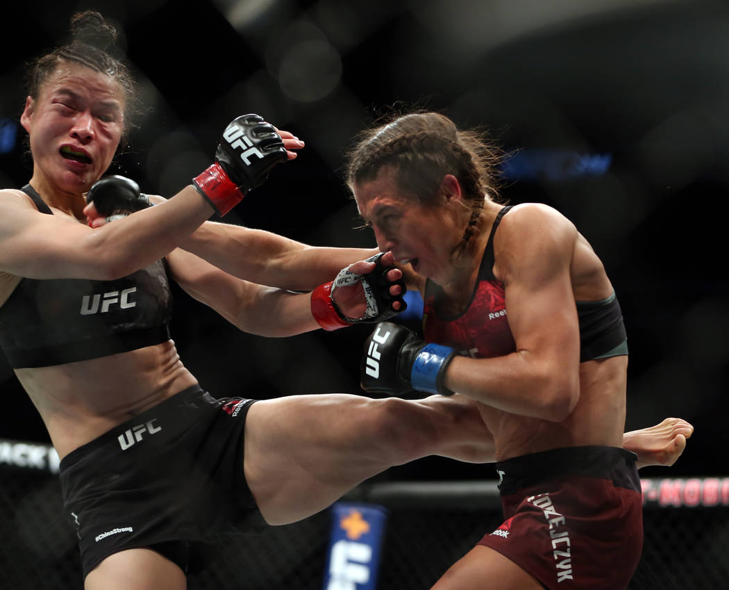 WomenÕs Strawweight Weili Zhang, left, and Joanna Jedrzejczyk trade blows d...