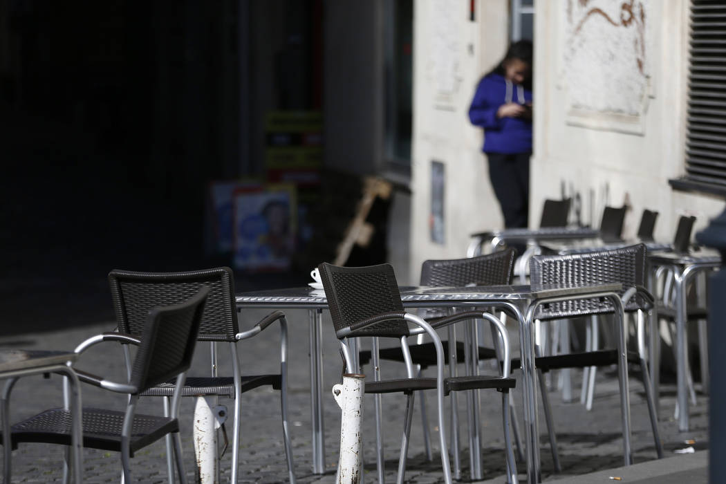 Chairs are empty at a cafe in Largo Argentina square amid growing concern about the spread of a ...