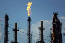 A flame burns at the Shell Deer Park oil refinery in Deer Park, Texas, in 2017. (AP Photo/Grego ...
