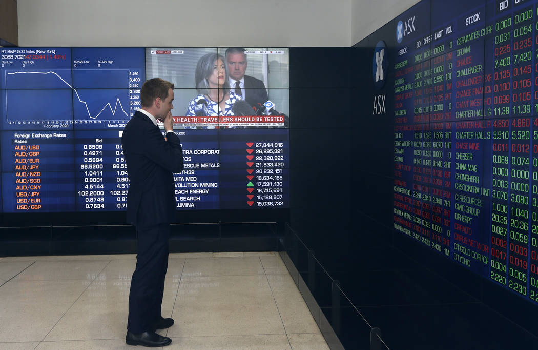 A man stands in the viewing gallery at the Australian Stock Exchange in Sydney, Monday, March 9 ...