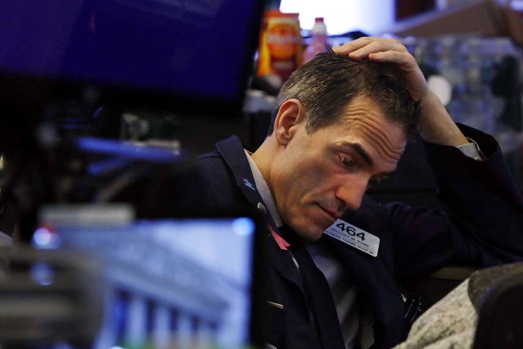 Trader Gregory Rowe prepares for the day's activity on the floor of the New York Stock Exchange ...