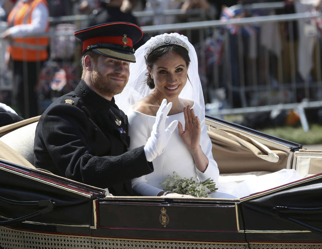 FILE - In this Saturday, May 19, 2018 file photo, Britain's Prince Harry and Meghan Markle ride ...