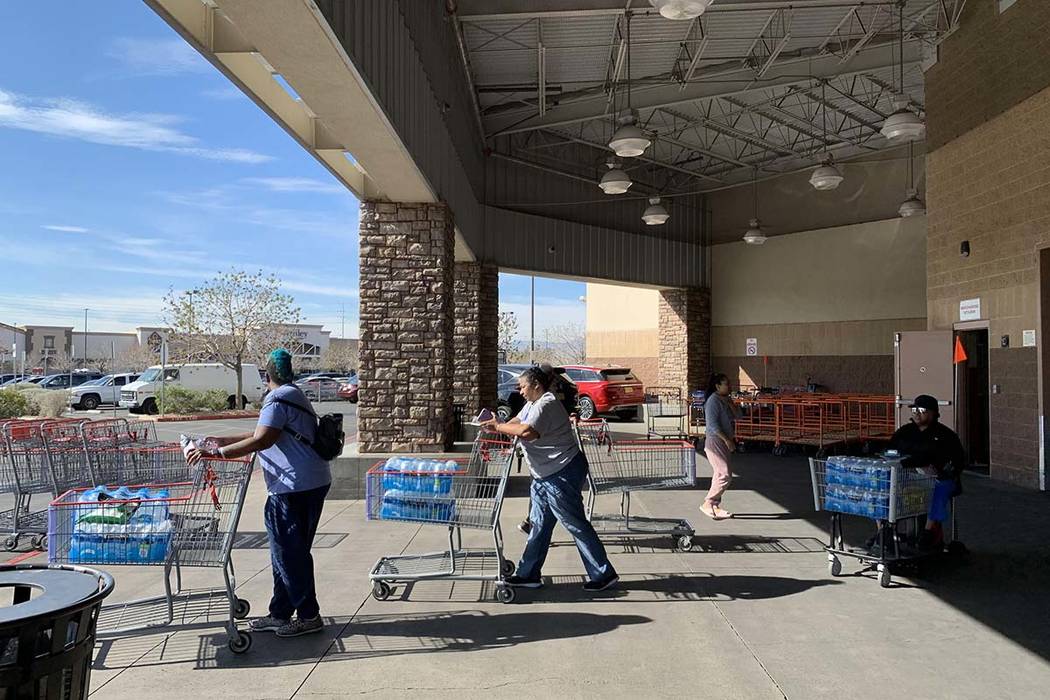 Customers at the Costco store at 6555 N. Decatur Blvd. in Las Vegas are stocking up on water an ...