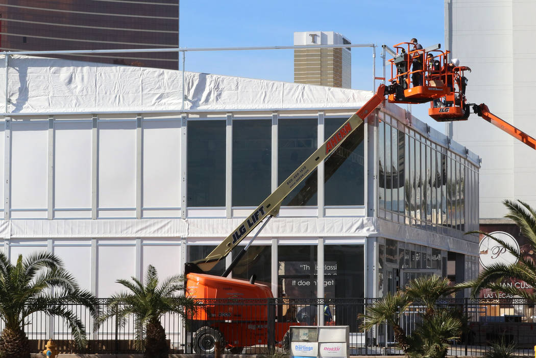 Workers install the APTIV's, a global technology company, booth ahead of CES on Friday, Dec. 2 ...