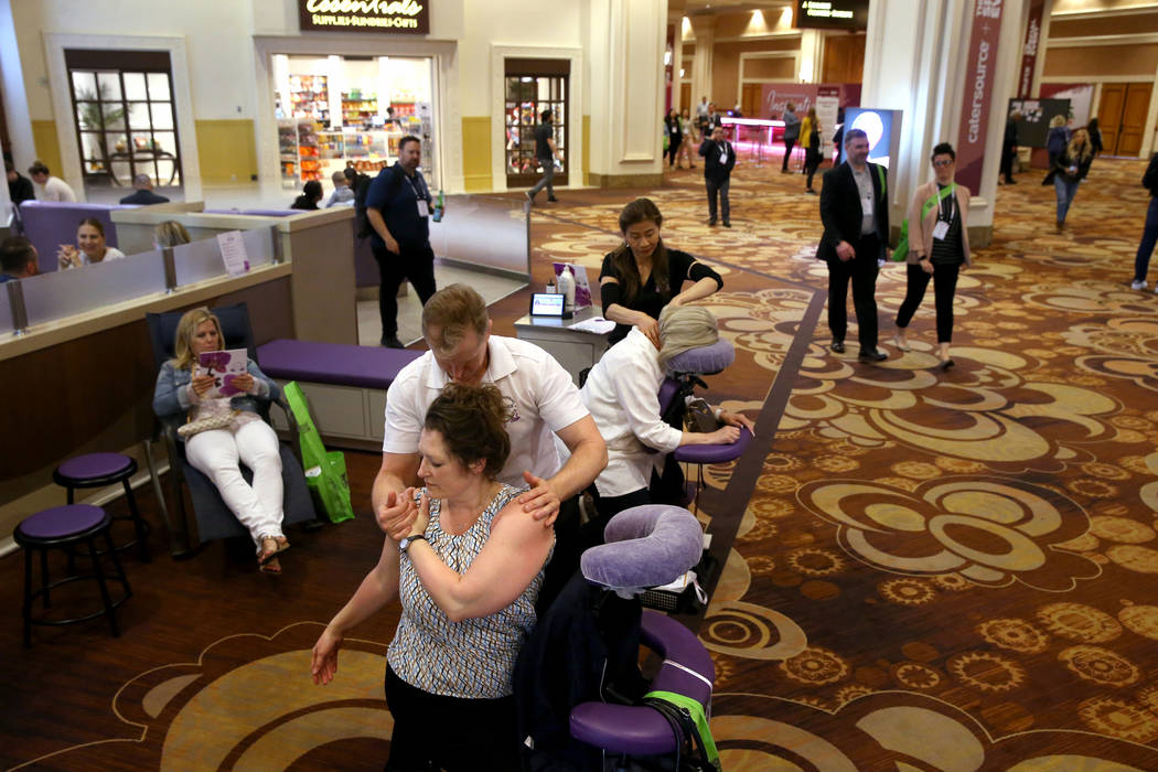 Las Vegas massage therapist Troy Miller of massages Alisha Jepsen of Ames, Iowa while Ling Cool ...