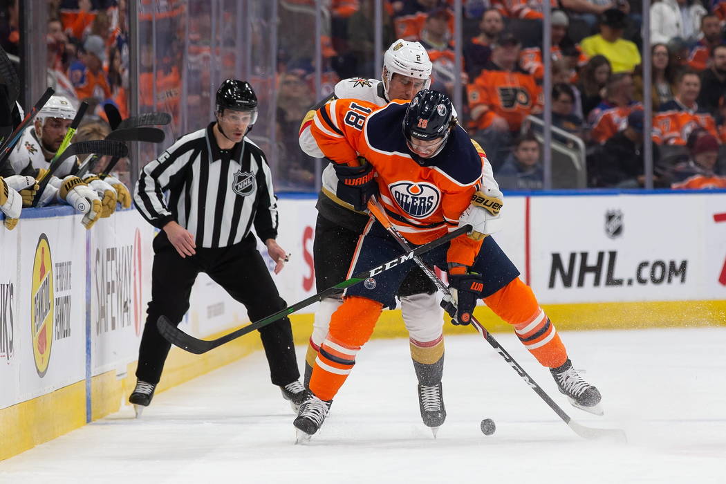 Edmonton Oilers' James Neal (18) battles against Vegas Golden Knights' Zach Whitecloud (2) duri ...