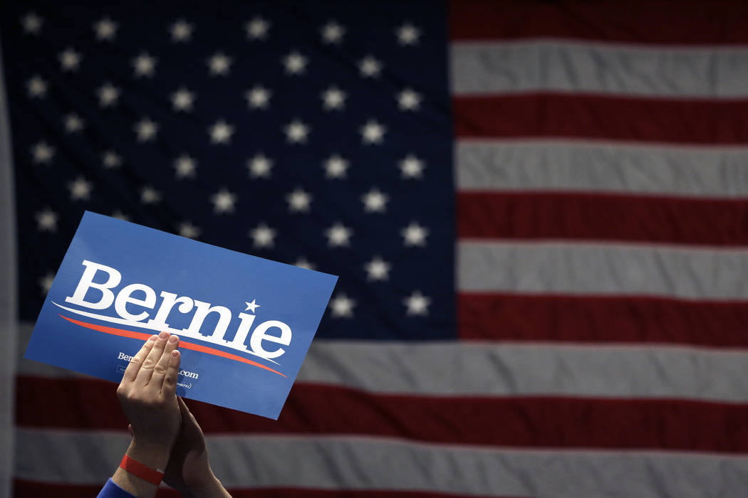 A supporter of Democratic presidential candidate Sen. Bernie Sanders, I-Vt., applauds as Sander ...