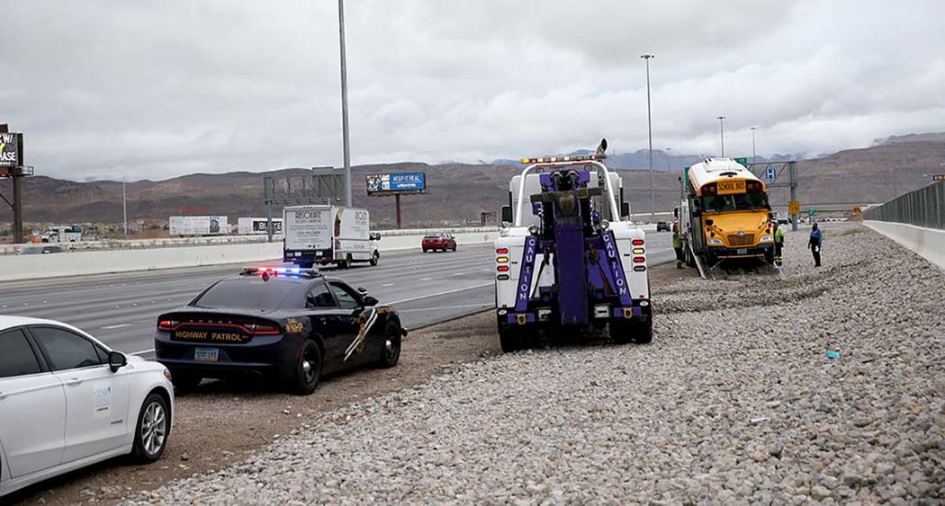 Clark County School District police, Nevada Highway Patrol and tow truck operators prepare to r ...