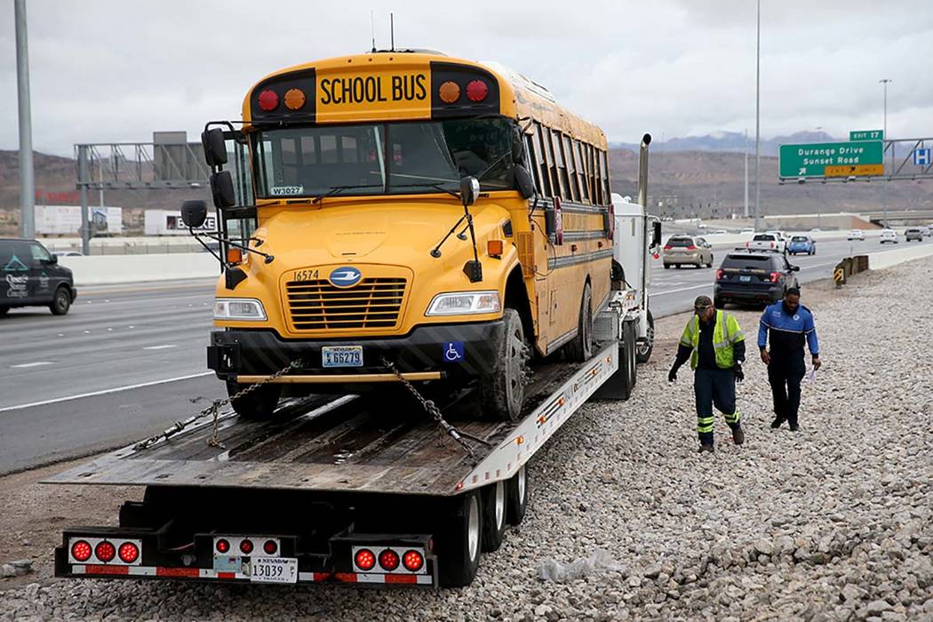 Clark County School District police, Nevada Highway Patrol and tow truck operators prepare to r ...