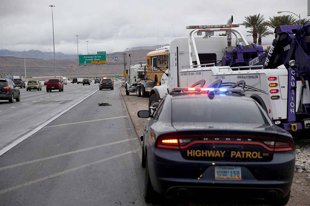 Clark County School District police, Nevada Highway Patrol and tow truck operators prepare to r ...