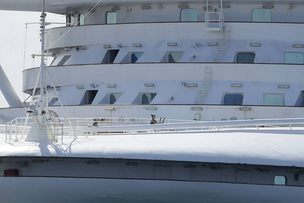 A woman uses excersise equipment on the Grand Princess, a cruise ship carrying multiple people ...