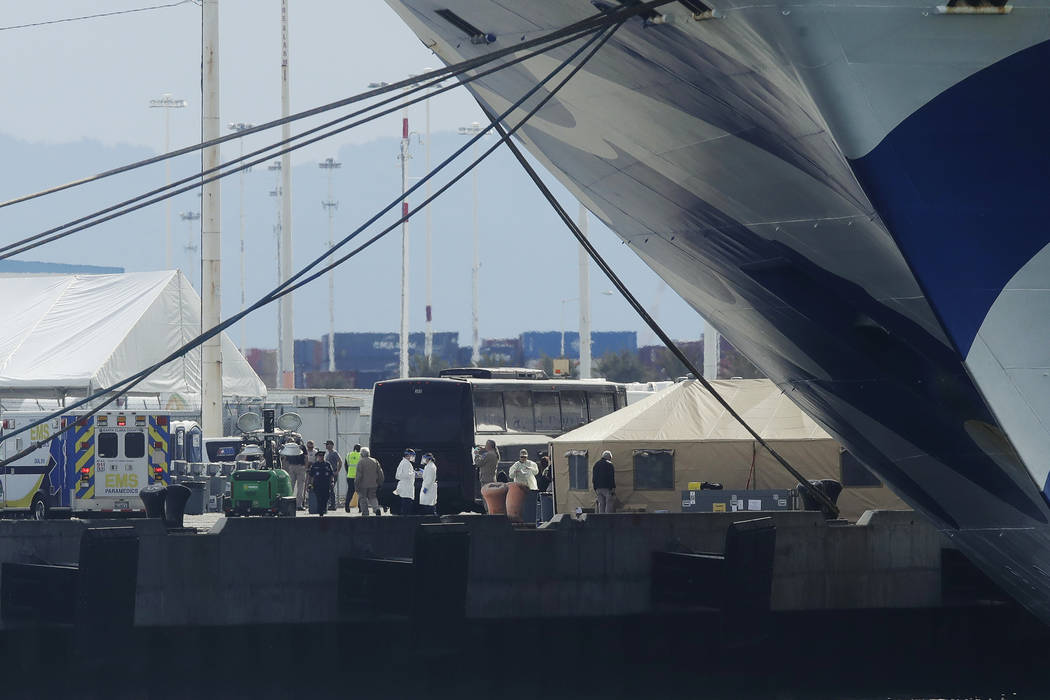 People wait below the Grand Princess, a cruise ship carrying multiple people who have tested po ...