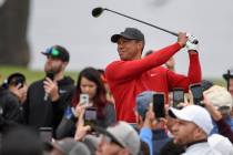 Tiger Woods watches his tee shot on the second hole of the South Course at Torrey Pines Golf Co ...