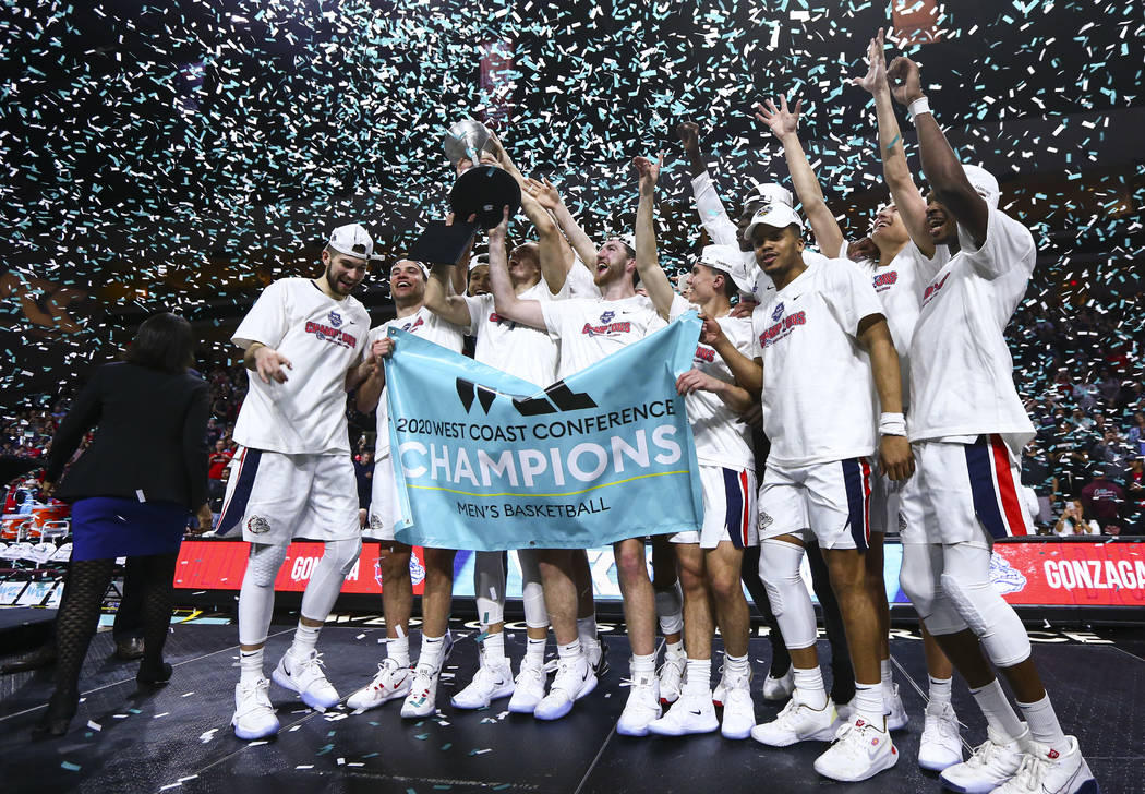 Gonzaga players celebrate after defeating St. Mary's to win the West Coast Conference tournamen ...