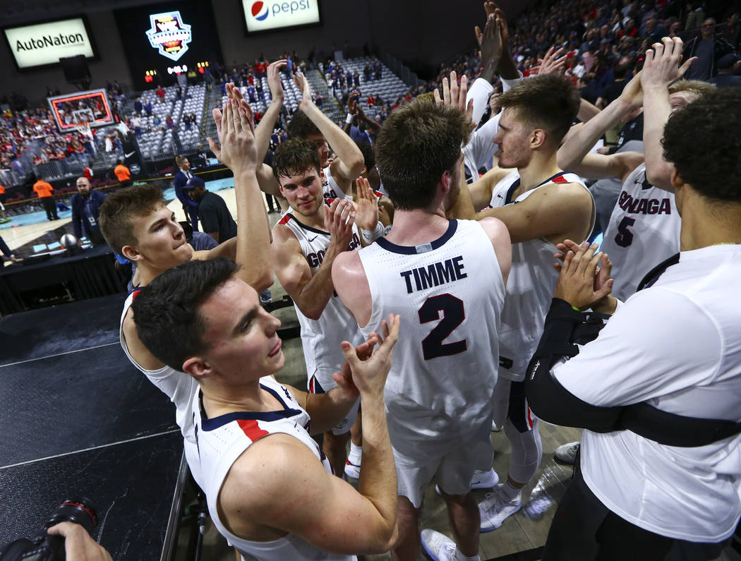 Gonzaga players celebrate after defeating St. Mary's to win the West Coast Conference tournamen ...