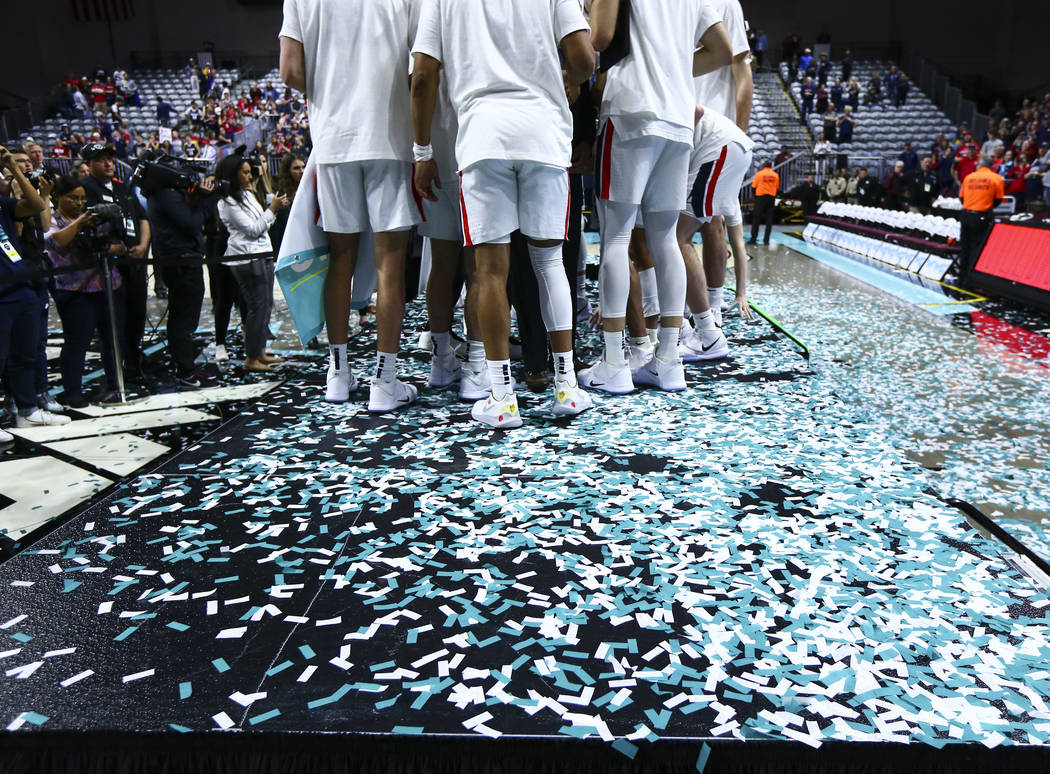 Gonzaga players celebrate after defeating St. Mary's to win the West Coast Conference tournamen ...