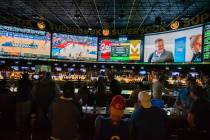 Basketball fans take in the first day of the NCAA Tournament at the Westgate Sportsbook on Marc ...