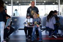 Brian Waldschmidt with his sons Caleb, 11, left, and Jayden, 12, of Las Vegas, wait in line to ...