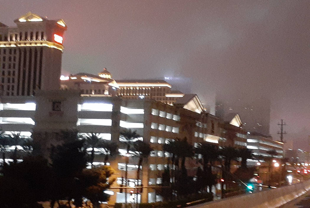 Clouds shroud Caesars Palace and other resorts on the Las Vegas Strip about 2:45 a.m. Wednesday ...