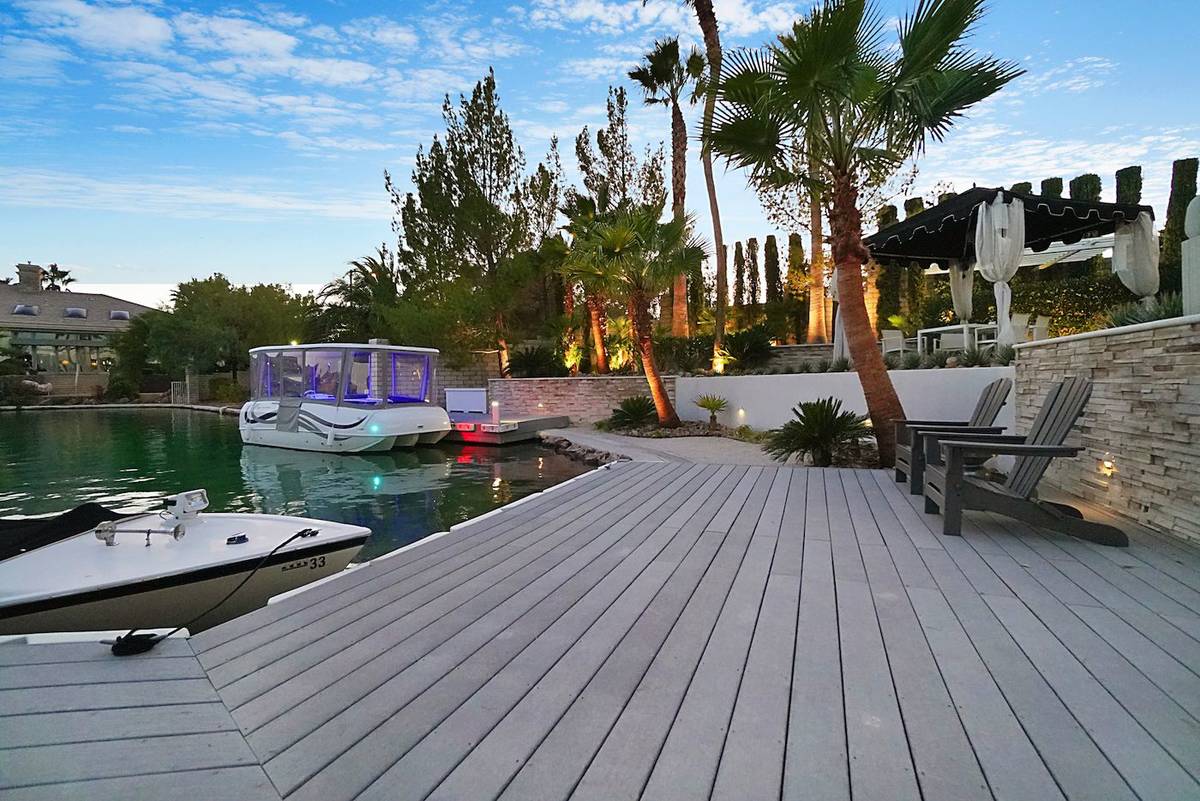 This mansion in the Lakes community at 2909 Coast Line Court comes with its own dock and boat. ...