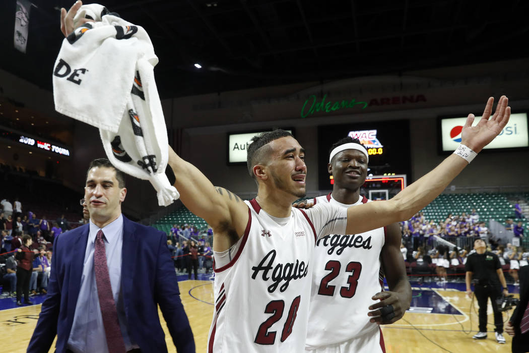 New Mexico State guard Trevelin Queen (20) and forward Mohamed Thiam (23) celebrate the team's ...