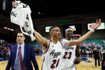 New Mexico State guard Trevelin Queen (20) and forward Mohamed Thiam (23) celebrate the team's ...
