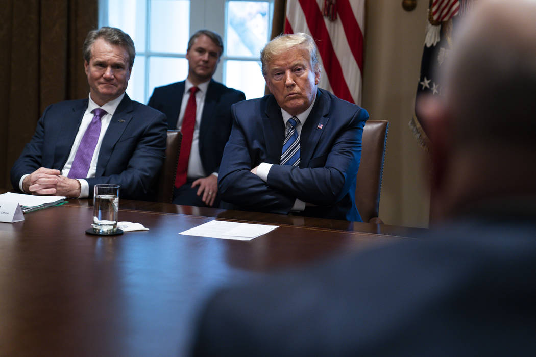 Bank of America CEO Brian Moynihan, left, and President Donald Trump listen during a meeting wi ...