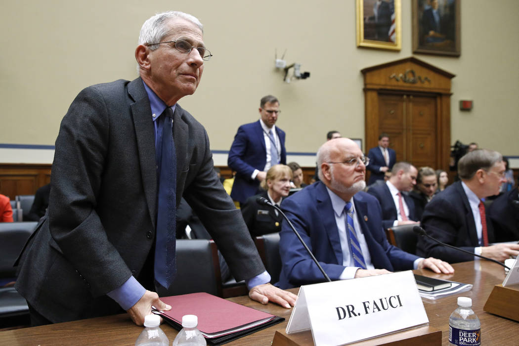 Dr. Anthony Fauci, left, director of the National Institute of Allergy and Infectious Diseases, ...
