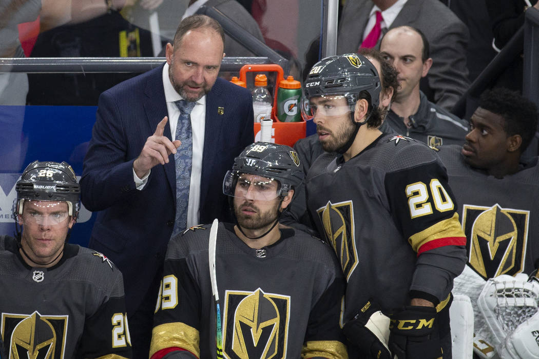 Golden Knights head coach Peter DeBoer talks with Vegas Golden Knights center Chandler Stephens ...