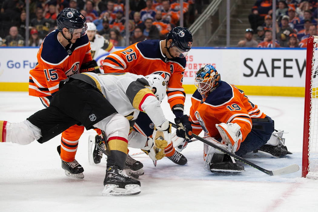 Edmonton Oilers' Darnell Nurse (25) and goaltender Mikko Koskinen (19) keep Vegas Golden Knight ...