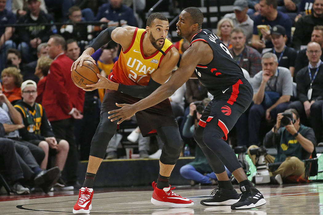 Toronto Raptors center Serge Ibaka (9) guards against Utah Jazz center Rudy Gobert (27) in the ...