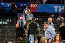 Basketball fans leave Chesapeake Energy Arena after it is announced that an NBA basketball game ...