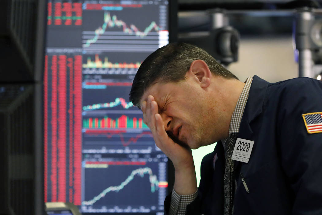 Trader Michael Gallucci works at his post on the floor of the New York Stock Exchange, Wednesda ...