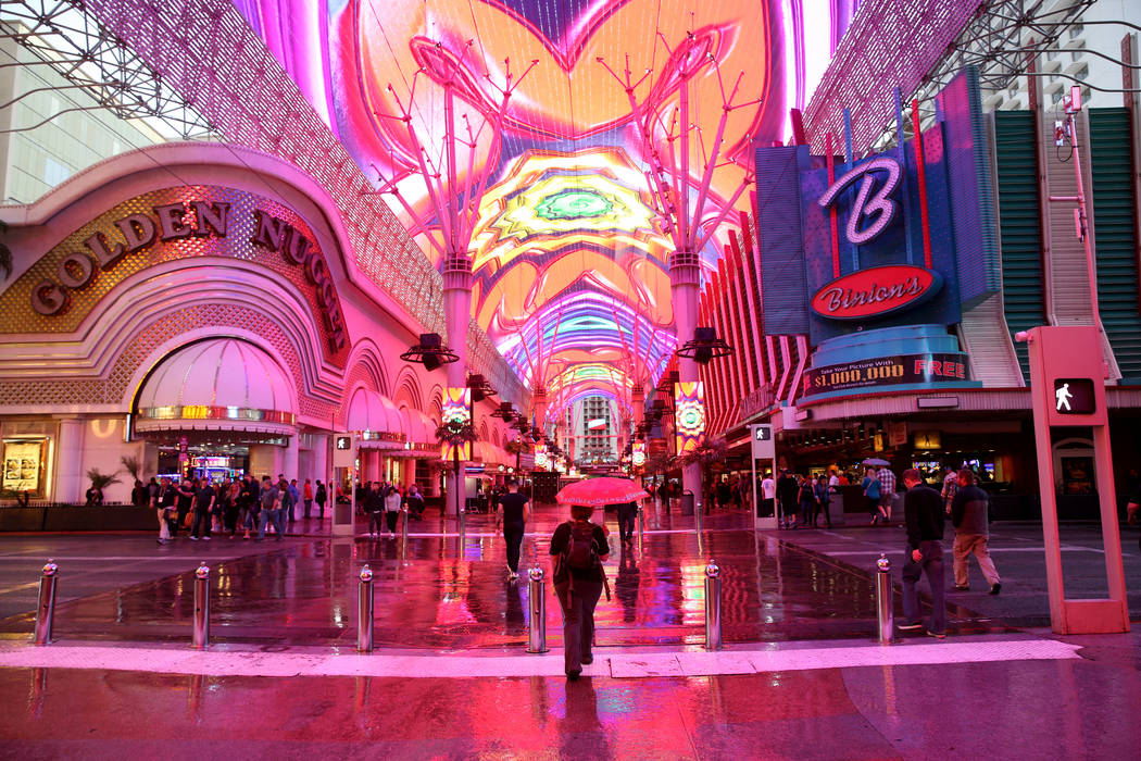 Tata Wicks of Las Vegas crosses Casino Center Boulevard at the Fremont Street Experience in dow ...