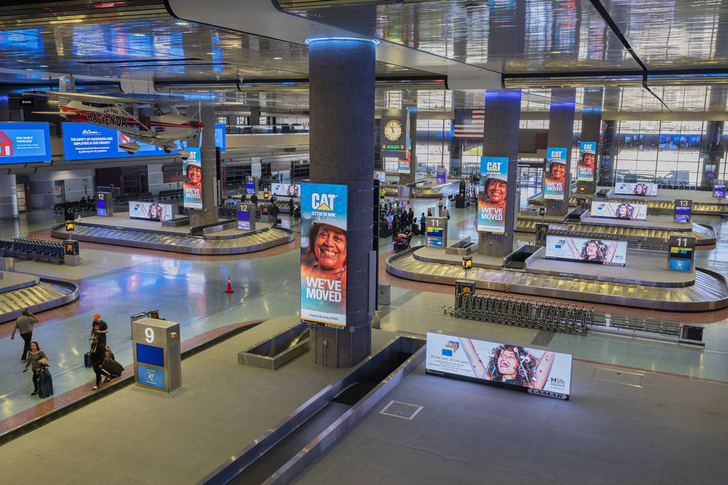 Passengers enter baggage claim at McCarran International Airport in Las Vegas on Thursday, Marc ...