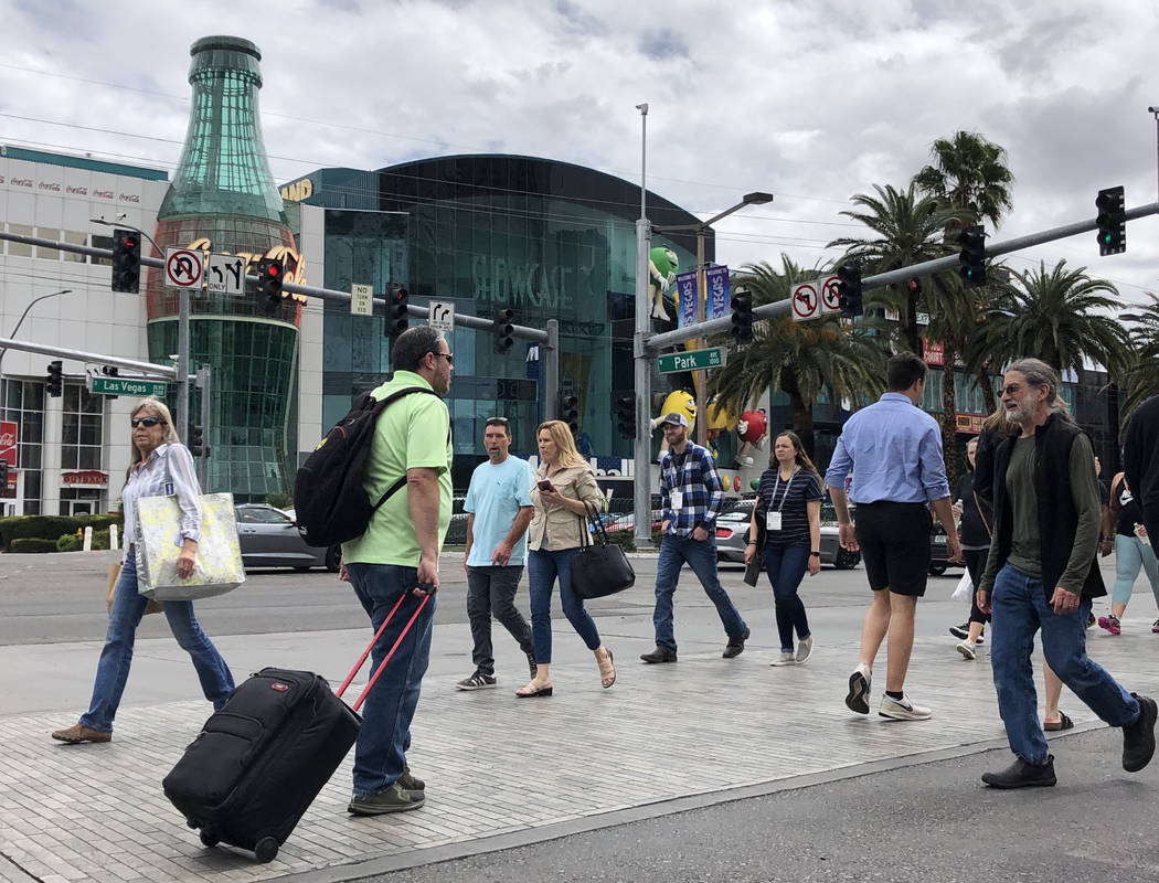 Visitors walk along the Strip on March 12, 2020, in Las Vegas. (Bizuayehu Tesfaye/Las Vegas Rev ...