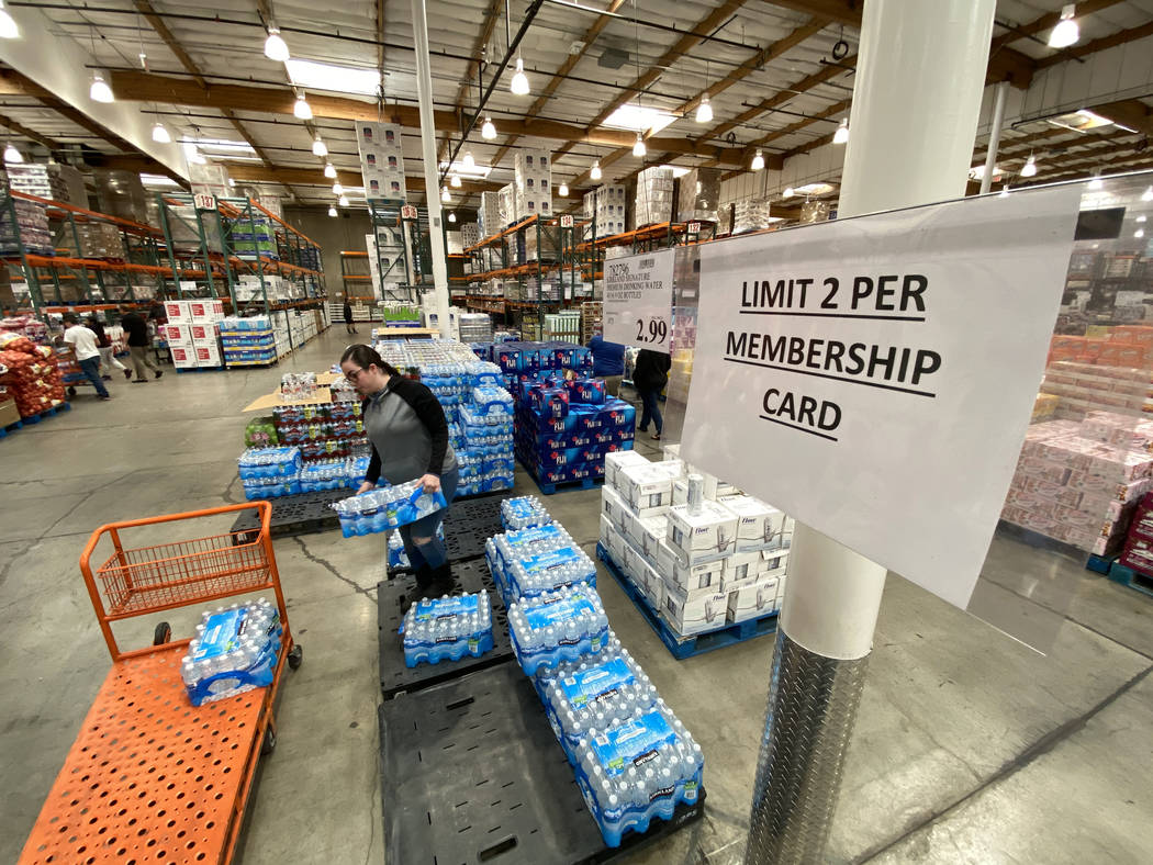 Shoppers, including Gisela Hernandez of Las Vegas, buy water at Costco at 222 S. Martin Luther ...