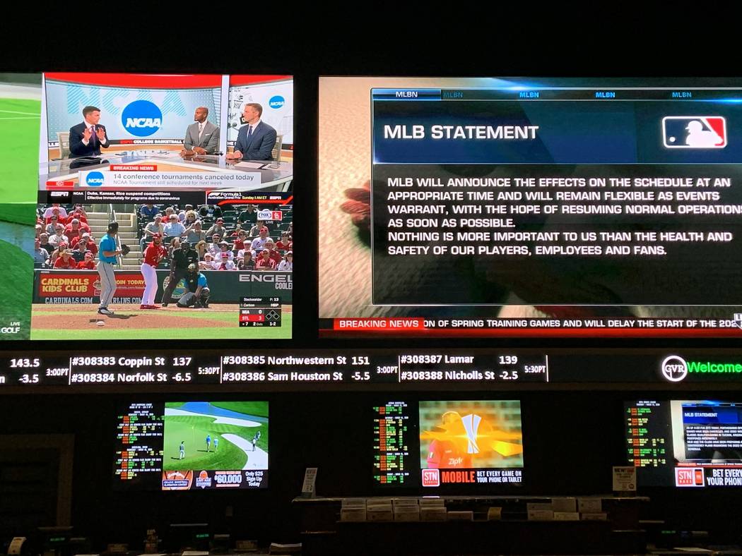 The main TVs at the Green Valley Ranch Resort sportsbook on Thursday show MLB exhibition games ...