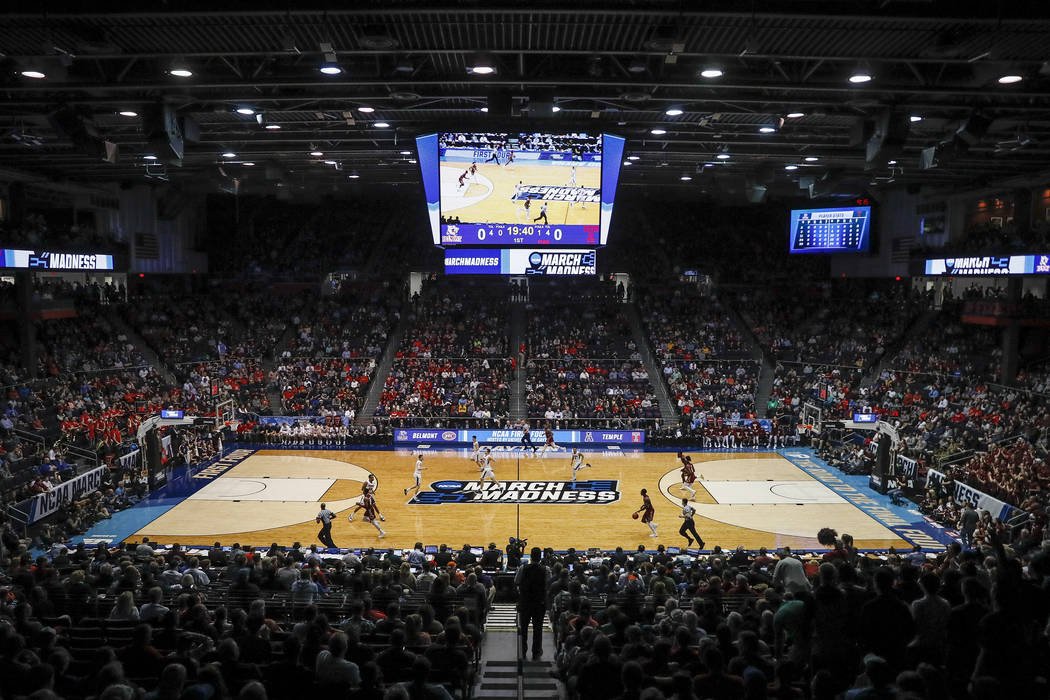 In this March 19, 2019, file photo, spectators watch from the stands during the first half of a ...