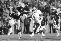 In this Jan. 22, 1984, file photo, Los Angeles Raiders running back Marcus Allen (32) outruns W ...