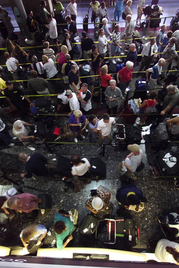 Travelers wind through ticket counter lines that stretched to the street at Southwest Airlines ...