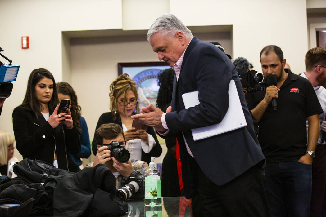 Gov. Steve Sisolak uses hand sanitizer before announcing a state of emergency at the Sawyer Bui ...